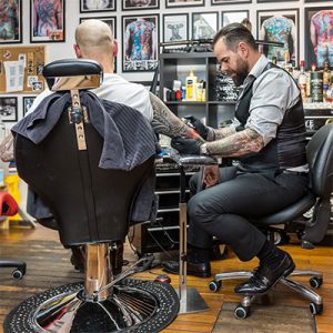 Tattooist using Bambach saddle seat